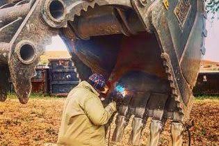 Heavy steel and bucket welding fabrication with sparks